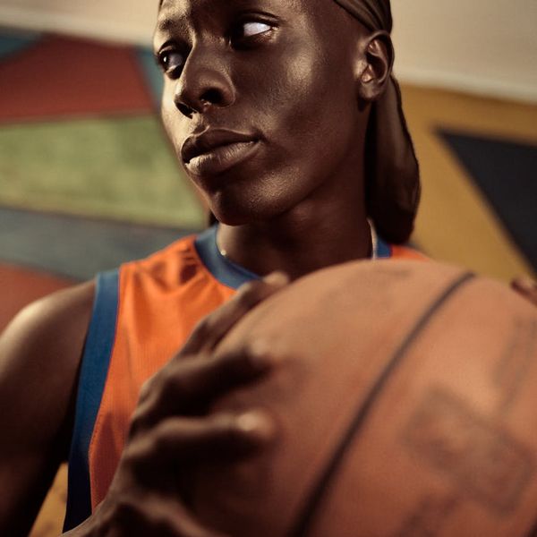 Man focused during a strength exercise in a dark room.